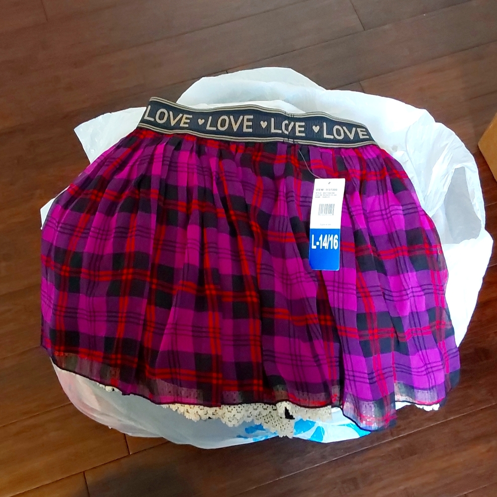 Youth short skirt Brand is Jessica Simpson.  Purple multicolored plaited